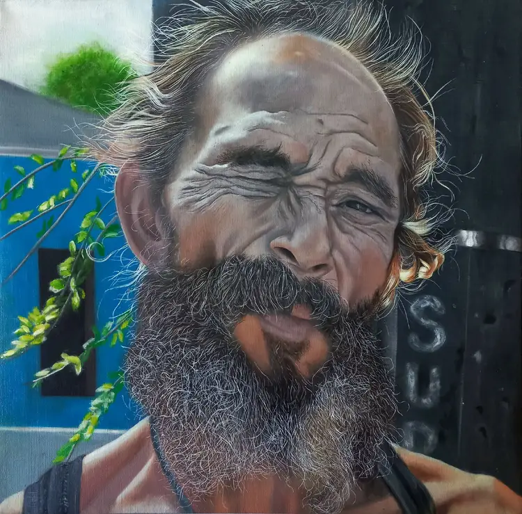 Street mural depicting a bearded man with weathered features and long hair, with green vines growing across the blue background behind it