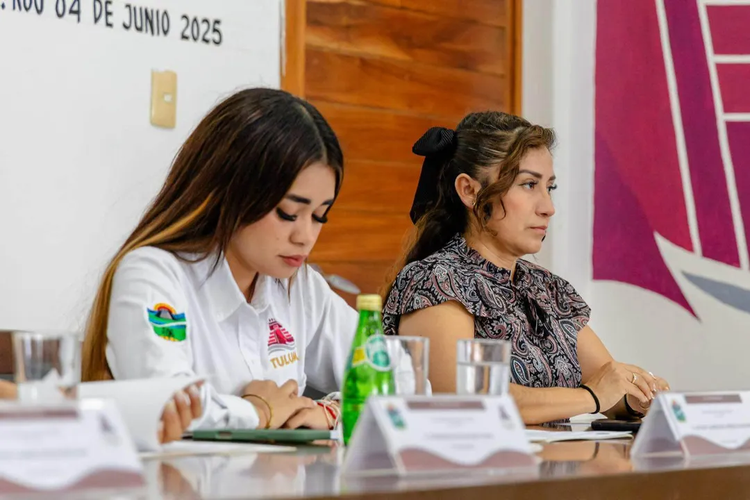 New Office to Field Human Rights Complaints Two women sit at a table during what appears to be an official meeting or press conference, with documents and water glasses in front of them