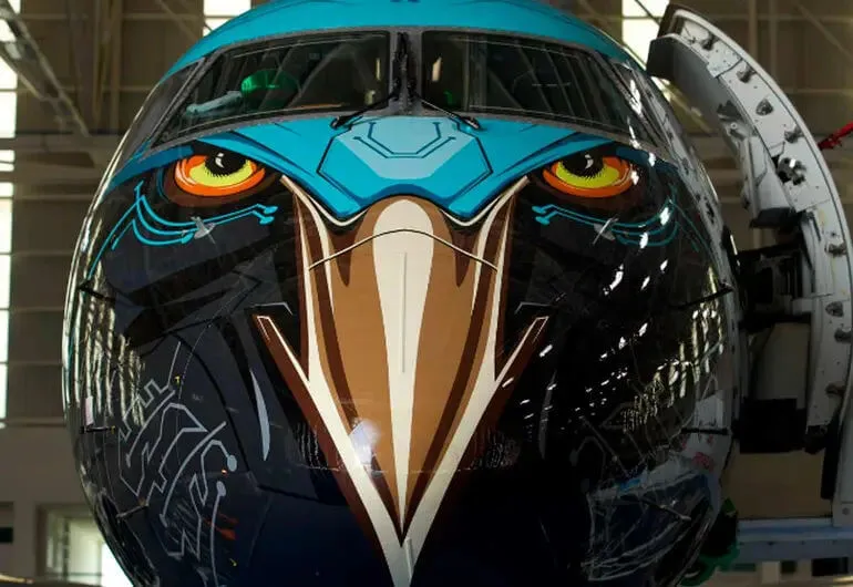 This Modest Jet to Tulum Is Hiding a Political Powerplay Commercial aircraft with a painted eagle face design featuring blue markings and large orange eyes on its nose cone