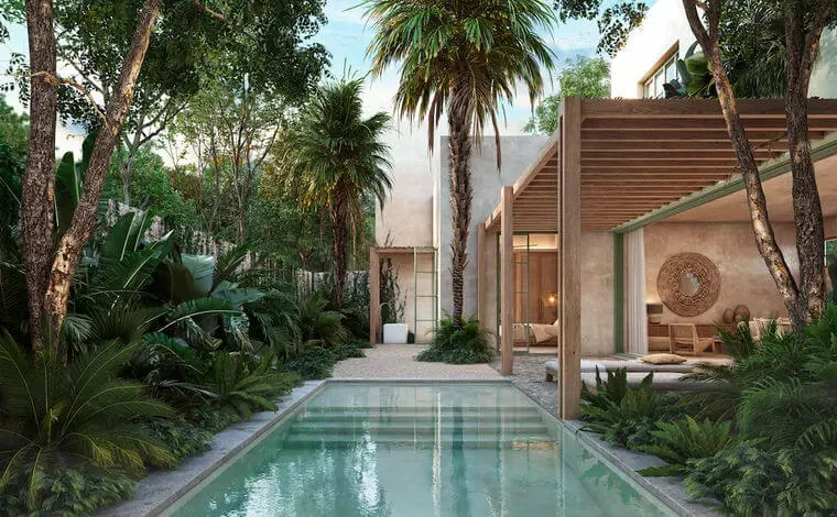 A narrow swimming pool runs between tall trees toward a modern house with brown wooden slatted walls nestled in tropical vegetation