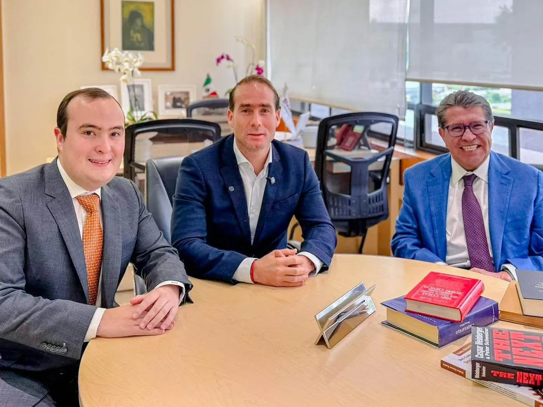Mexico approves law for free public beach entry nationwide Three men in business suits sit at a conference table in an office, with books and papers in front of them
