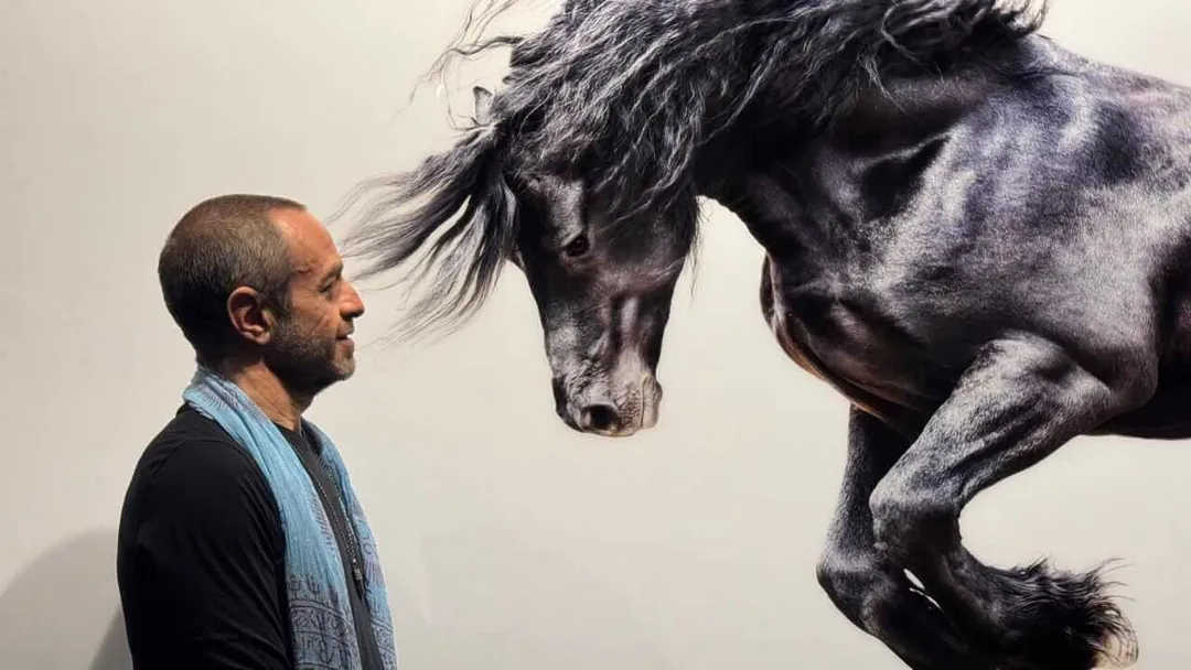 Pepe Soho, creator of Mystika Museum in Tulum, dies at 52 Man in profile gazes at a large mural of a black horse's head on a white wall