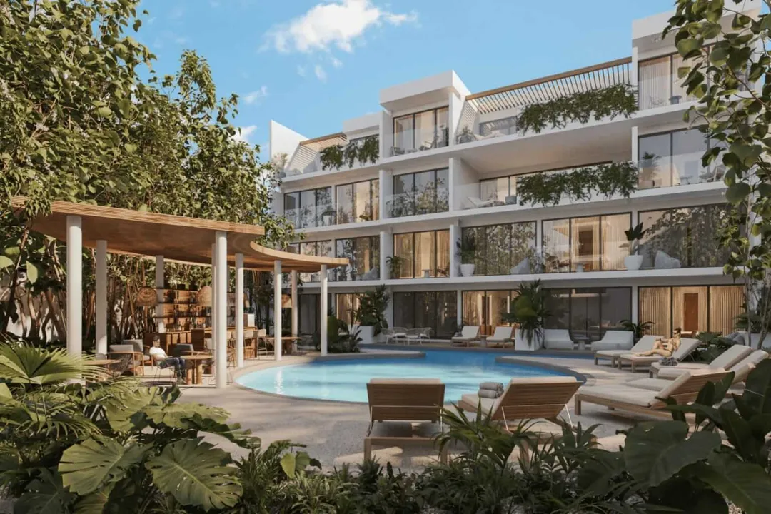 Modern residential building with pool and lounge chairs surrounded by tropical plants and wooden pergola structures