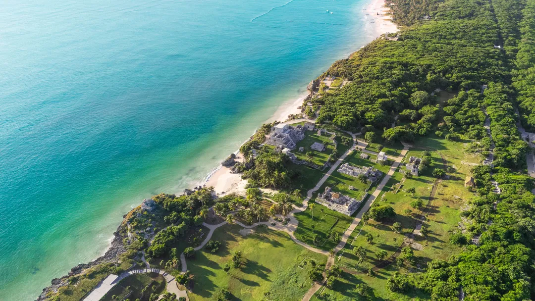 New alliance puts UMusic Hotel Tulum at the center of Mexico's Tulum Renace strategy Aerial view of a beachfront resort with buildings and manicured grounds nestled between turquoise ocean water and dense green forest