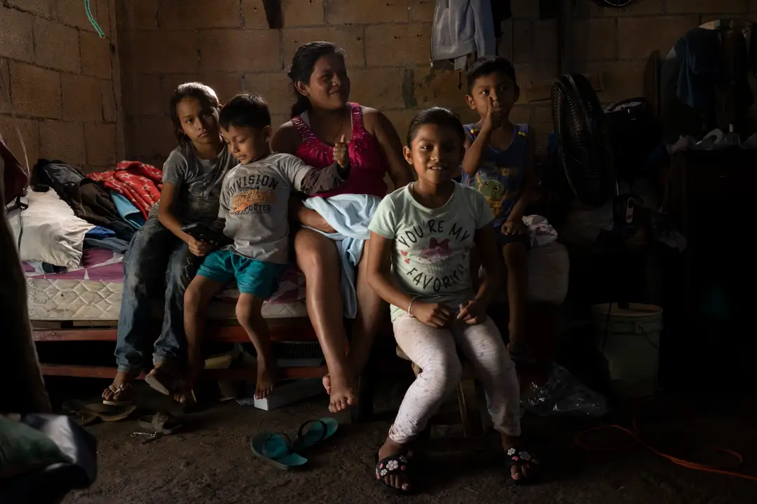 Tulum's job losses are a mental health problem too, the HR association warns A family of five sits together on a bed in a sparse concrete room with minimal belongings visible around them