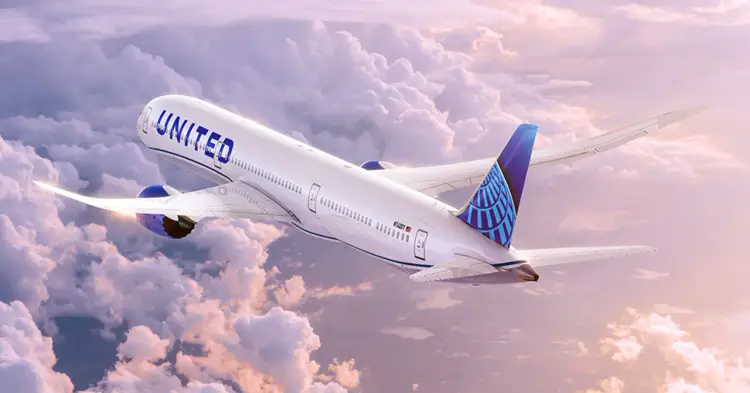 Commercial airliner with United livery flying through clouds at altitude