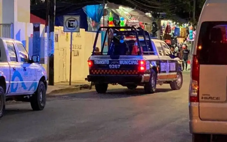 Municipal transit vehicle parked on a street at night between police cars and other vehicles