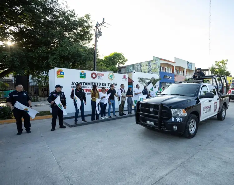 Police officers stand near a vehicle and municipal tent at a public gathering in an urban plaza Police officers stand near a vehicle and municipal tent at a public gathering in an urban plaza