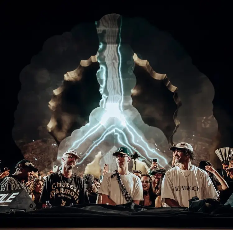 Musicians perform at a nighttime festival stage with a large illuminated skeleton projection behind them Musicians perform at a nighttime festival stage with a large illuminated skeleton projection behind them