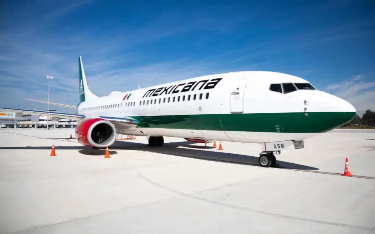 Commercial airliner with white fuselage and green stripe parked on airport tarmac with safety cones nearby Commercial airliner with white fuselage and green stripe parked on airport tarmac with safety cones nearby