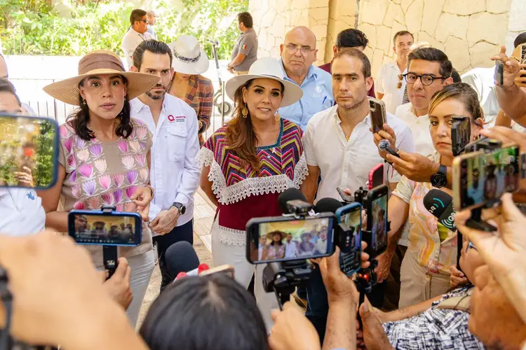 Group of officials and media representatives gather outdoors as journalists photograph and record them with smartphones and cameras Group of officials and media representatives gather outdoors as journalists photograph and record them with smartphones and cameras