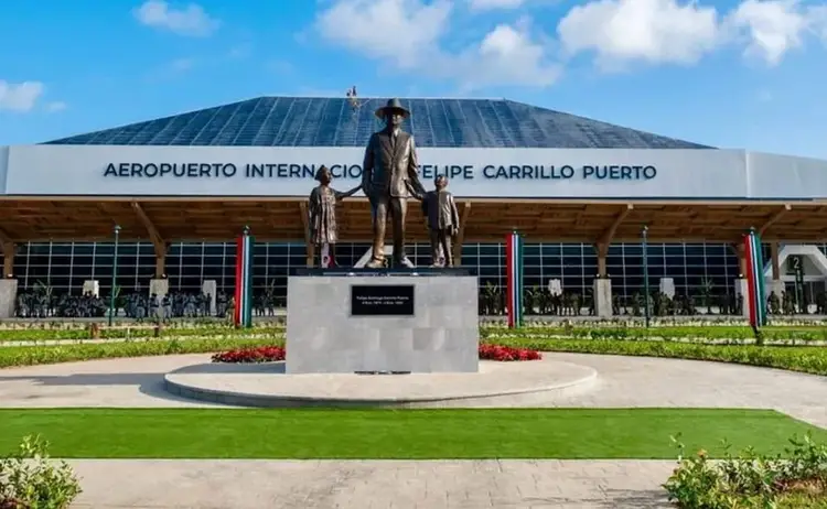 Bronze statue of an adult and child on a pedestal in front of an airport terminal building with manicured landscaping Bronze statue of an adult and child on a pedestal in front of an airport terminal building with manicured landscaping