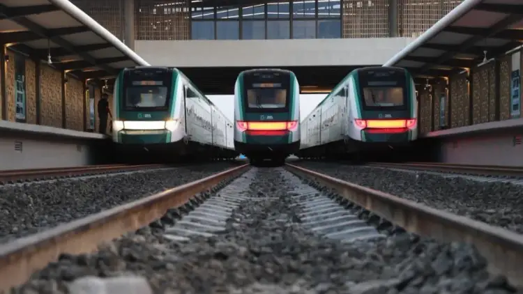 Three passenger trains lined up on parallel tracks in an underground station with brick walls and overhead lighting Three passenger trains lined up on parallel tracks in an underground station with brick walls and overhead lighting