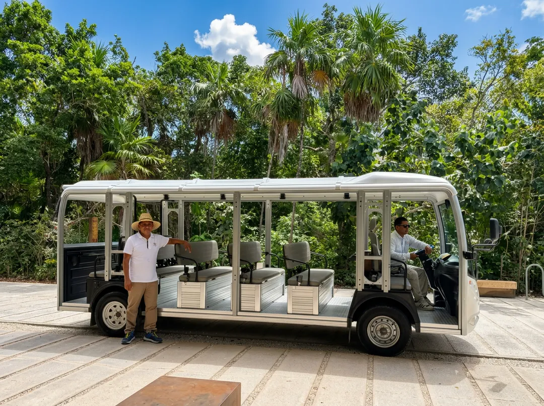 Dozens of families lose income as Jaguar Park cuts staff Tour tram with several passengers stopped on a paved pathway with tropical trees and palm trees in the background