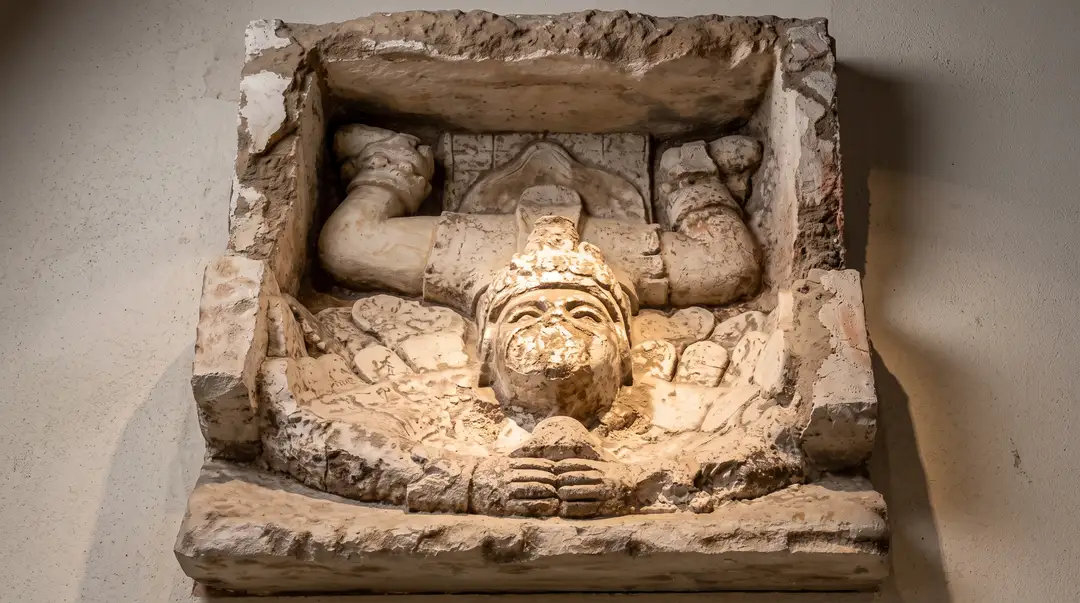 Tulum's ruins take 3,000 people a day. The free museum next door drew 98,400 Stone architectural ornament carved with a face and decorative elements mounted on a white wall