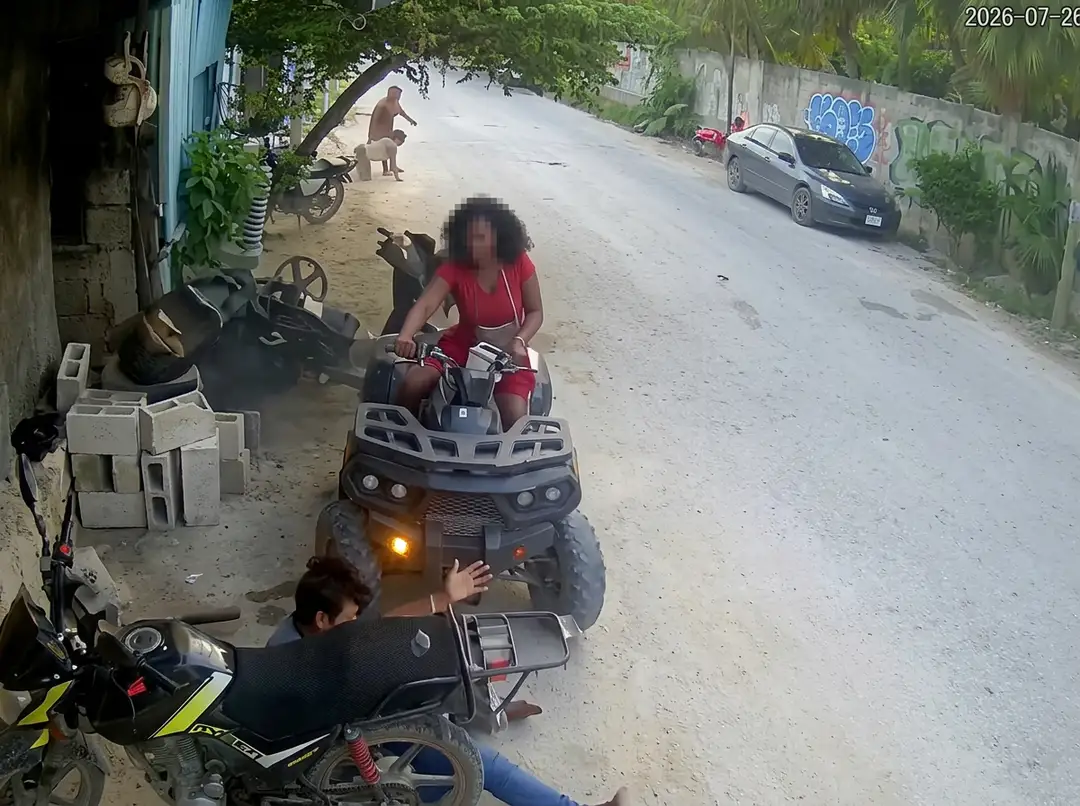 A camera recorded the ATV striking a pregnant woman. Tulum's rules never define it Woman in red shirt riding an ATV on a sandy street while man sits on motorcycle in foreground