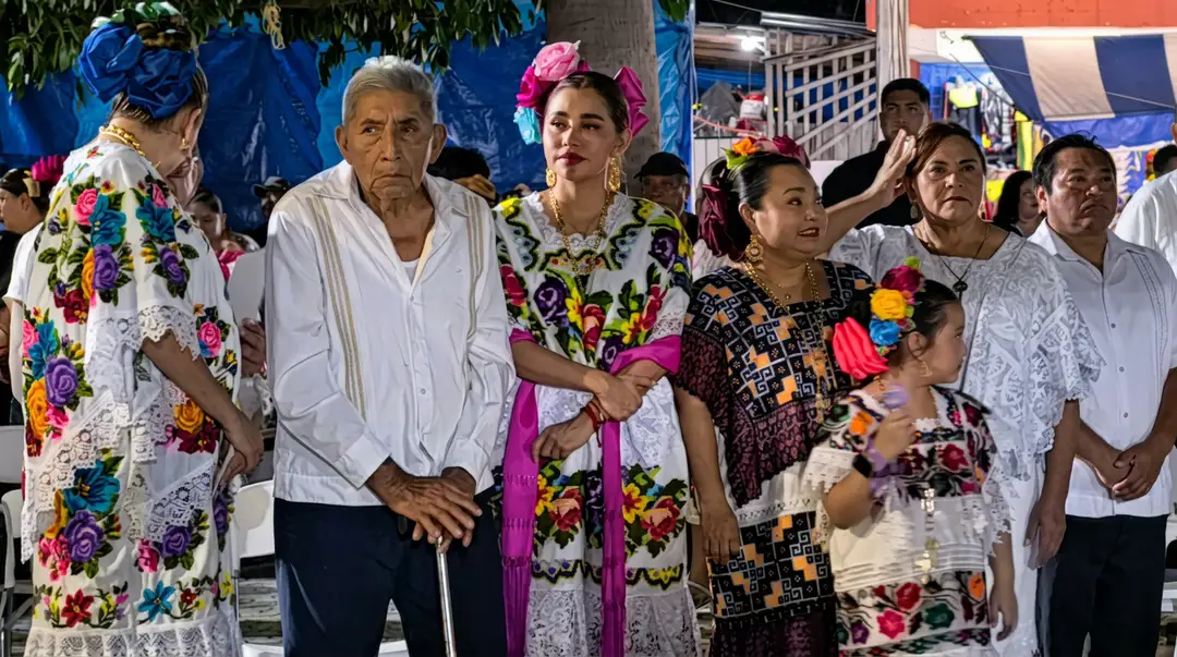 Tulum’s Maya families give thanks for a harvest the late rains never let grow People wearing embroidered traditional clothing and colorful flower garlands stand together at an outdoor gathering