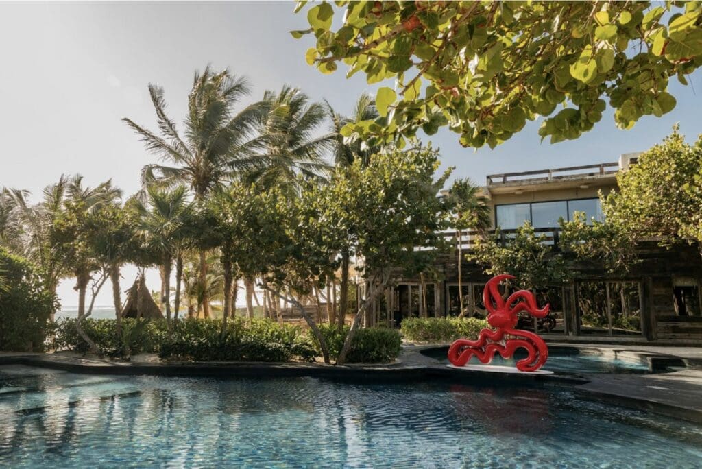 Casa Malca in Tulum, once owned by Pablo Escobar, has been transformed into a luxury hotel by art dealer Lio Malca, blending history, art, and luxury.